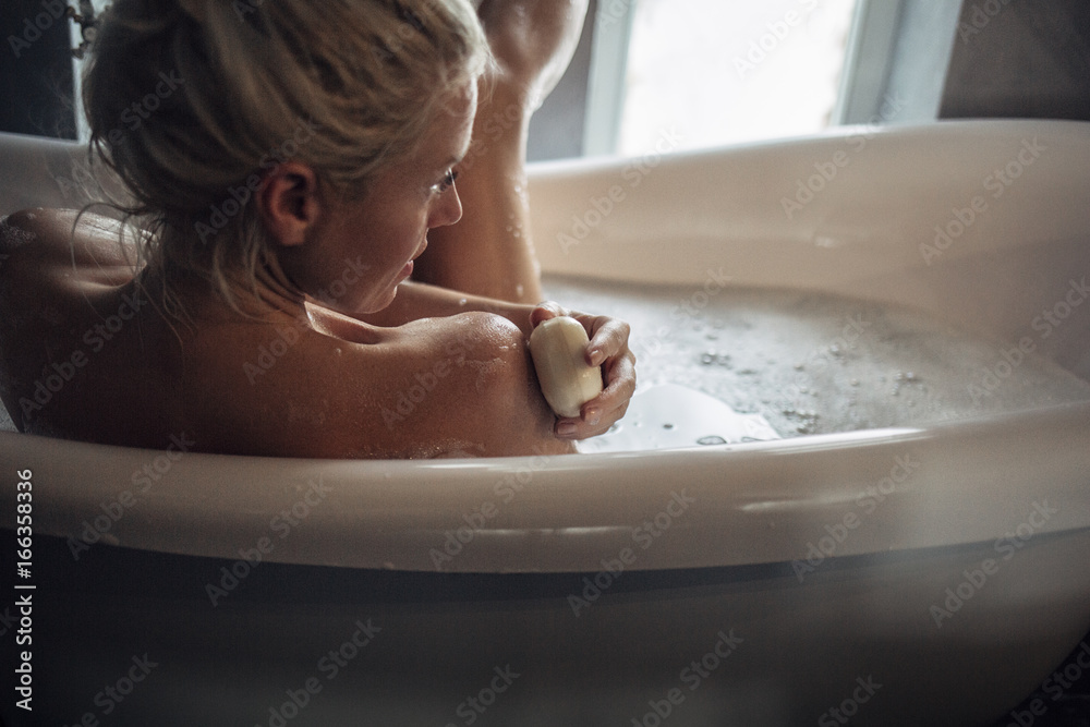 Woman Washing Her Shoulder With a Soap Woman Washing Her Shoulder With a Soap