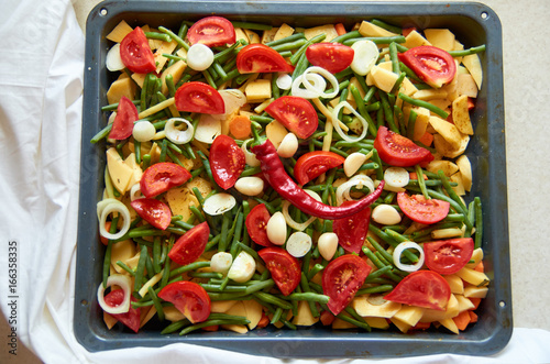 Grilled fresh vegetables with chili peper on white background. Grilled mix of vegetables in a baking tray. Vegetables mix. Top view