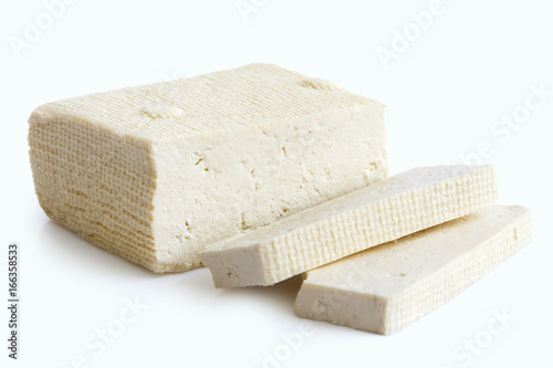 Fotografie Block of white tofu and two slices isolated on white.