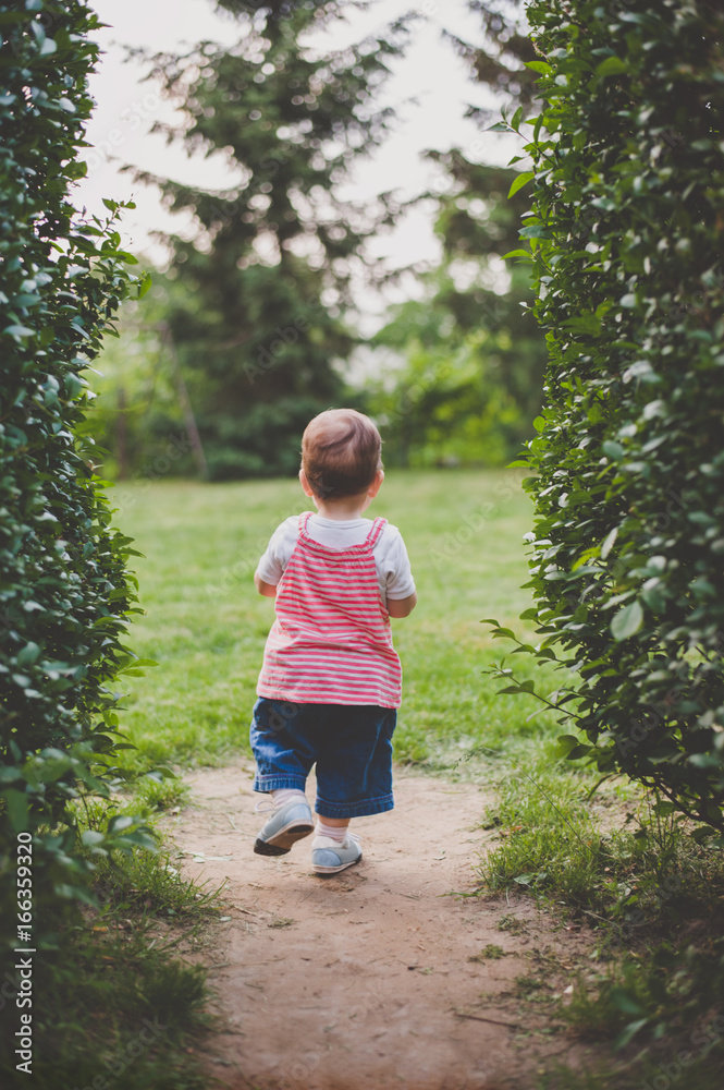 Back of a toddler girl walking confidently photographed from behind. Back of a toddler girl walking confidently photographed from behind.