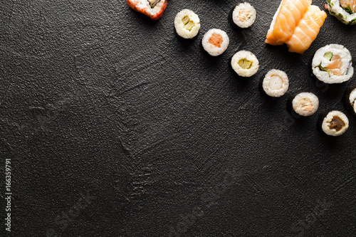 Japanese sushi rolls on black table