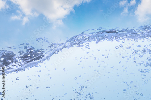 Wave of drinking water and bubble air white sky background.