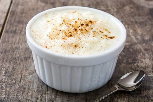 Arroz con leche. Rice pudding with cinnamon on wooden background
