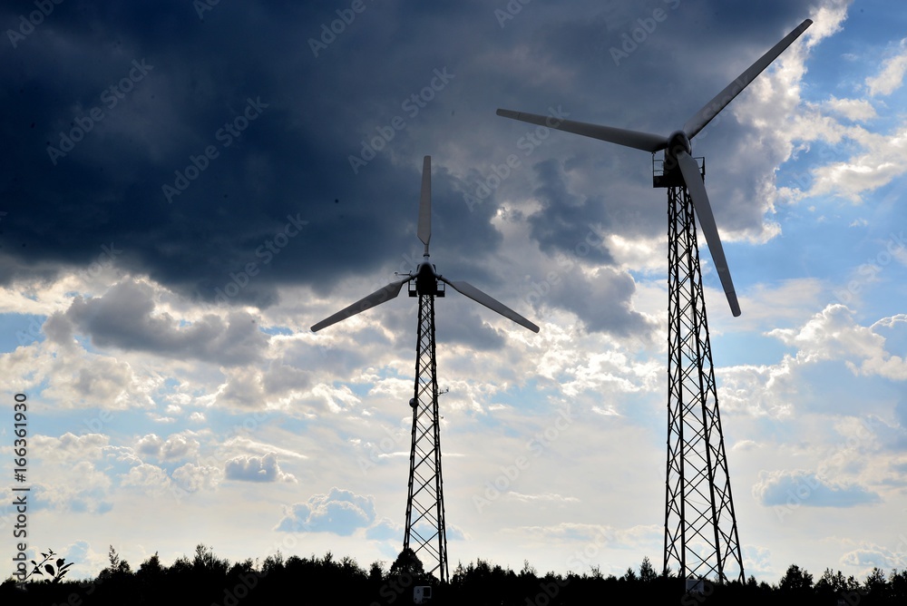 A wind farm or windmills producing energy against the sky