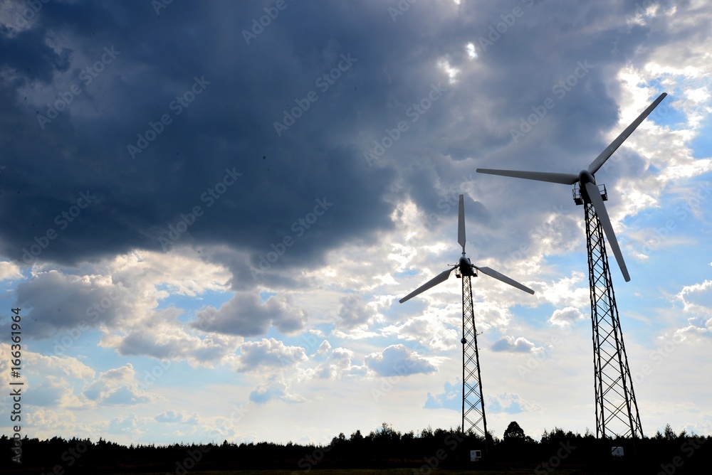 A wind farm or windmills producing energy against the sky