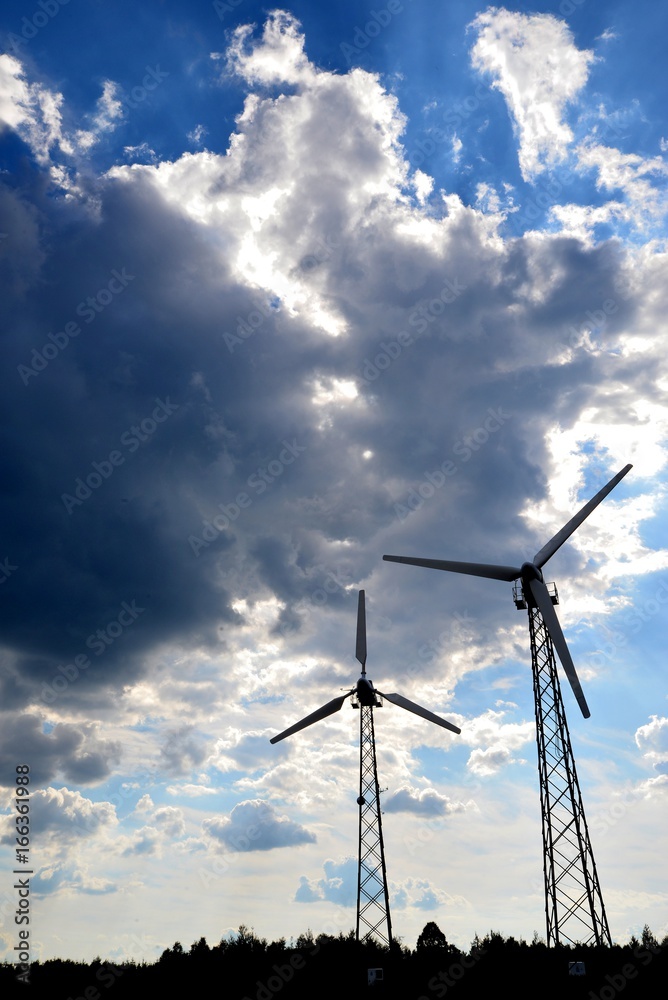 A wind farm or windmills producing energy against the sky