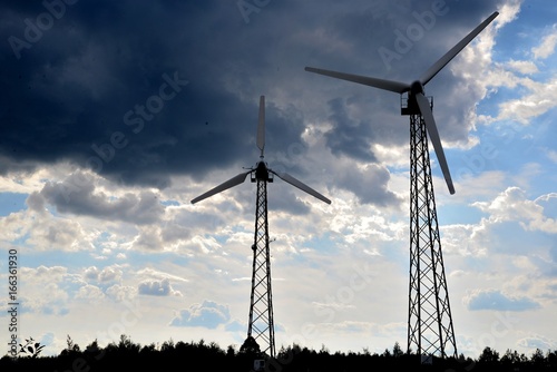 Obraz na płótnie A wind farm or windmills producing energy against the sky w salonie