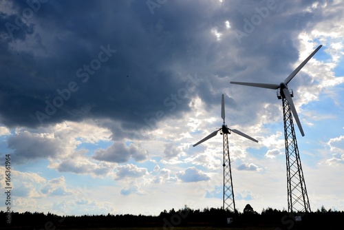 Obraz na płótnie A wind farm or windmills producing energy against the sky w salonie