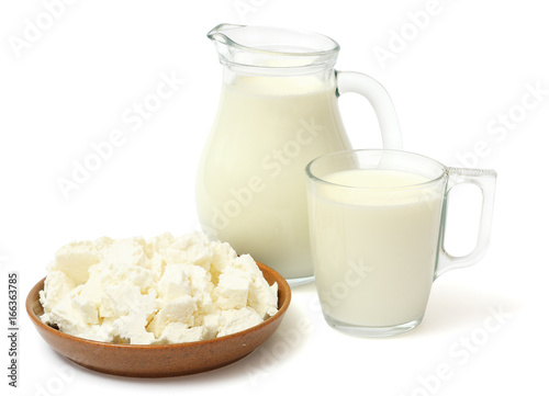 Glass jug pitcher of fresh milk with glass and cottage cheese isolated on white background carafe