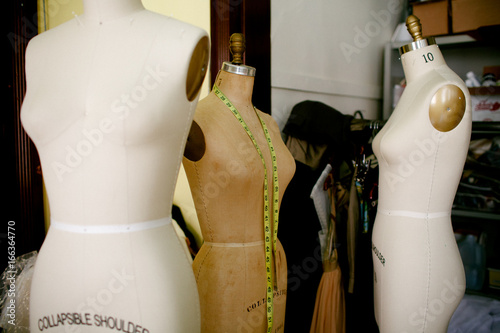 3 dress forms with measuring tape.
