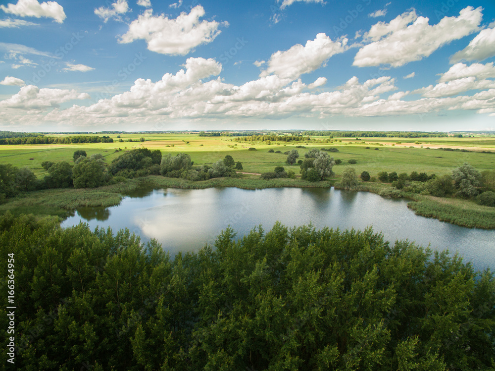 Aerial view of a lake in rural landscape with beautiful blue sky
Aerial view of a lake in rural landscape with beautiful blue sky