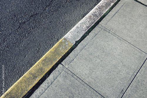 Painted curb along sidewalk and urban street