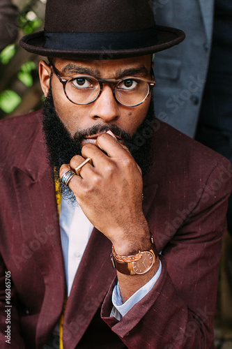 Portrait of a dapper studious gentleman wearing reading glasses photo