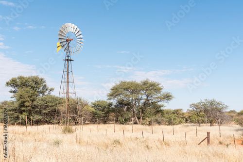 Farm scene with water-pumping windmill on the B1-road photo