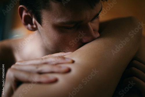 Close up shot of a man kissing his partner's leg