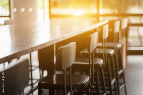 Selective focus of table and chair of coffee shop inside view with vintage color tone