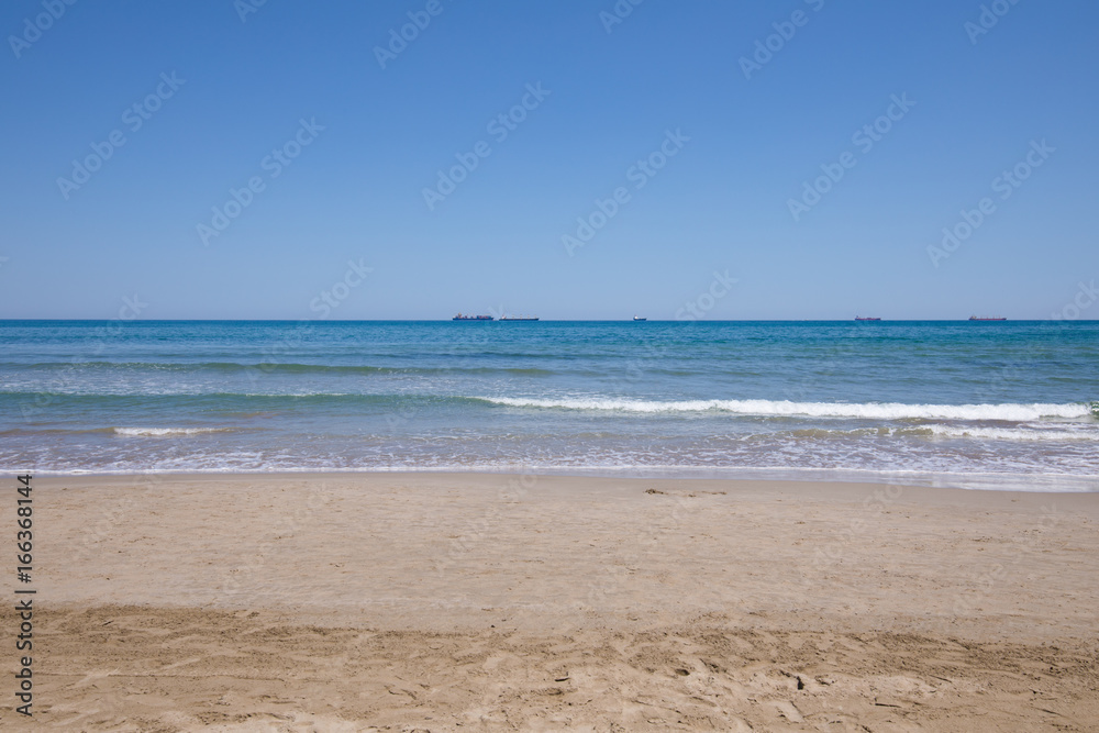 landscape of Mediterranean Sea from sand shore beach of Grao of Castellon, in Valencia, Spain, Europe. Blue clear sky, and great cargo boats sailing in the horizon
landscape of Mediterranean Sea from sand shore beach of Grao of Castellon, in Valencia, Spain, Europe. Blue clear sky, and great cargo boats sailing in the horizon