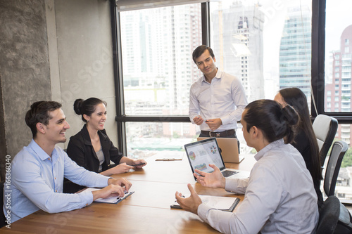 Businessman standind for present the project with team, Portrait business leader concept, 20-30 year old. photo