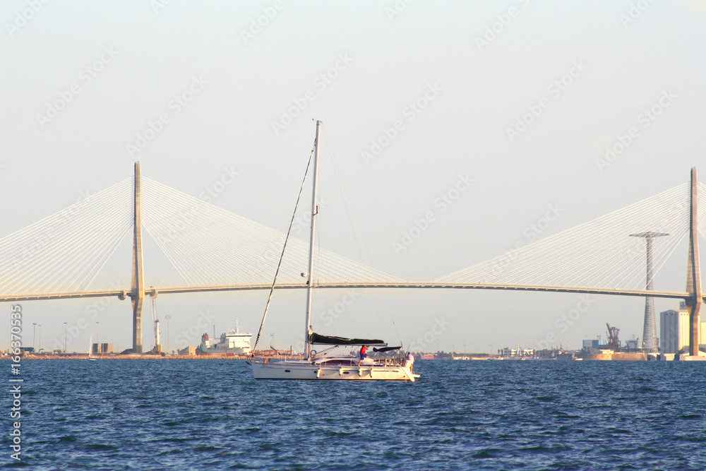 sailing boats on the background of the huge bridge
