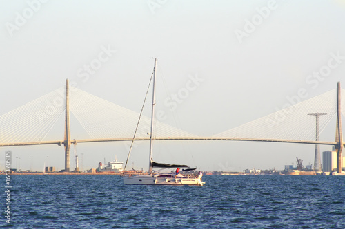 sailing boats on the background of the huge bridge