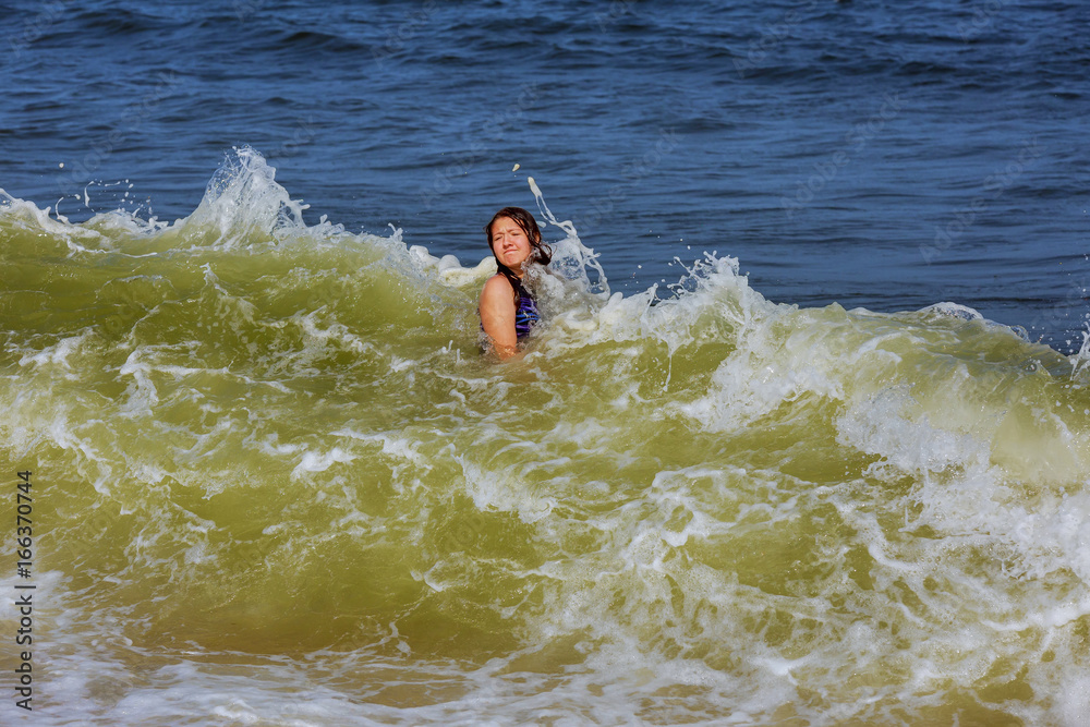 girl bathes in waves