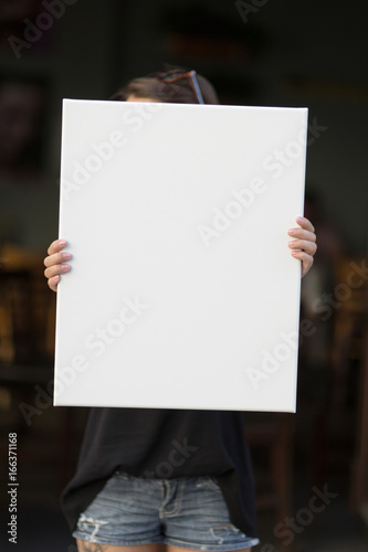 Girl holds a frame for a poster presentation