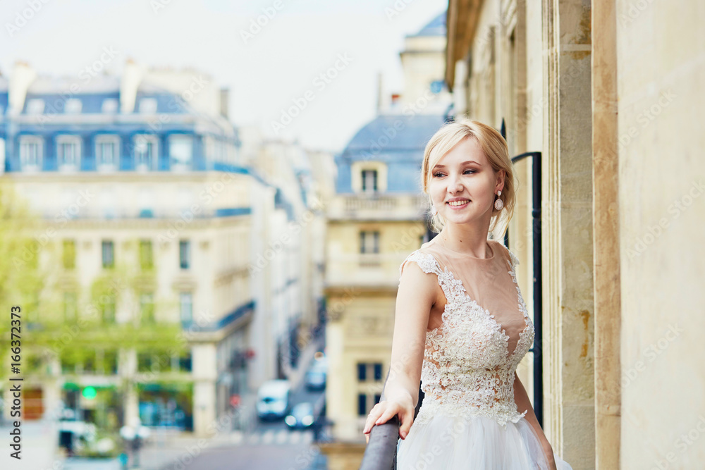 Beautiful young bride on the balcony of her home or hotel room