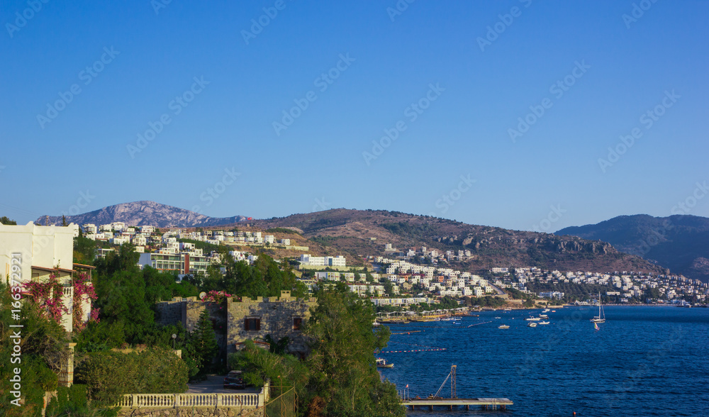 View of the Gumbet Bay. Mountainous terrain near the Aegean Sea. Typical buildings on the mountain near the sea. Bodrum. Turkey.