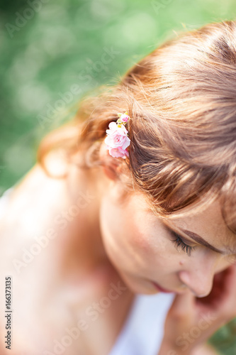 Young beautiful woman walks in flowery Park. Portrait of a young woman. Happy girl. Summer.