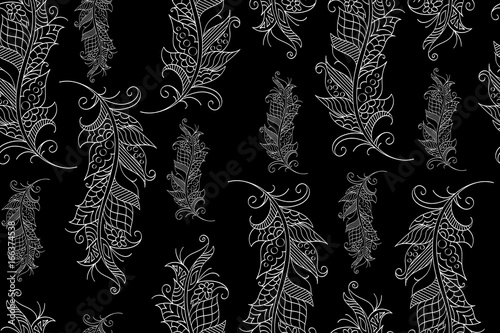 Seamless pattern with hand drawn feathers in mehndi style, vector. There is a swatch in the panel. Elements are not cut off and hidden under mask