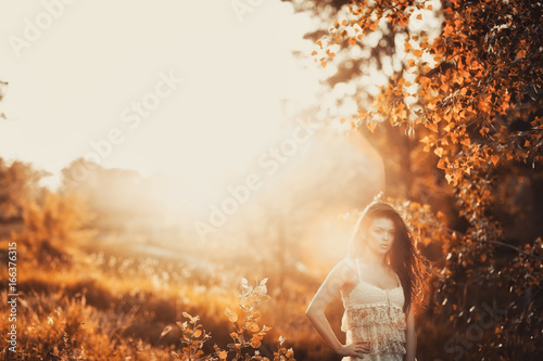 Brunette girl in short dress in a park