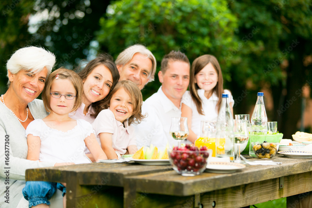 Big Family Having A Picnic In The Garden