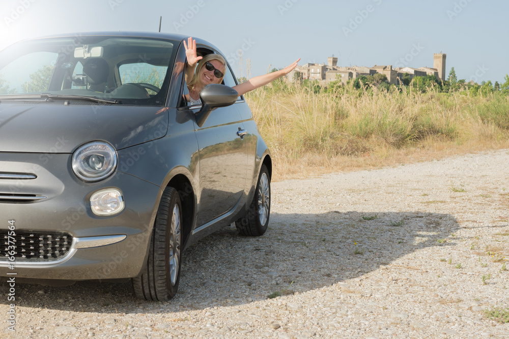 Happy young girl is traveling by car