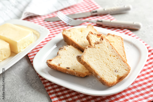 Plate with delicious sliced butter cake on table
