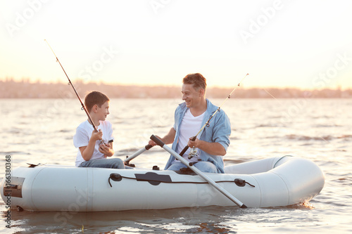 Dad and son fishing from in...