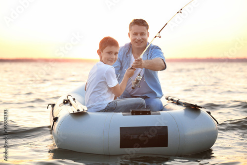 Dad and son fishing from in...