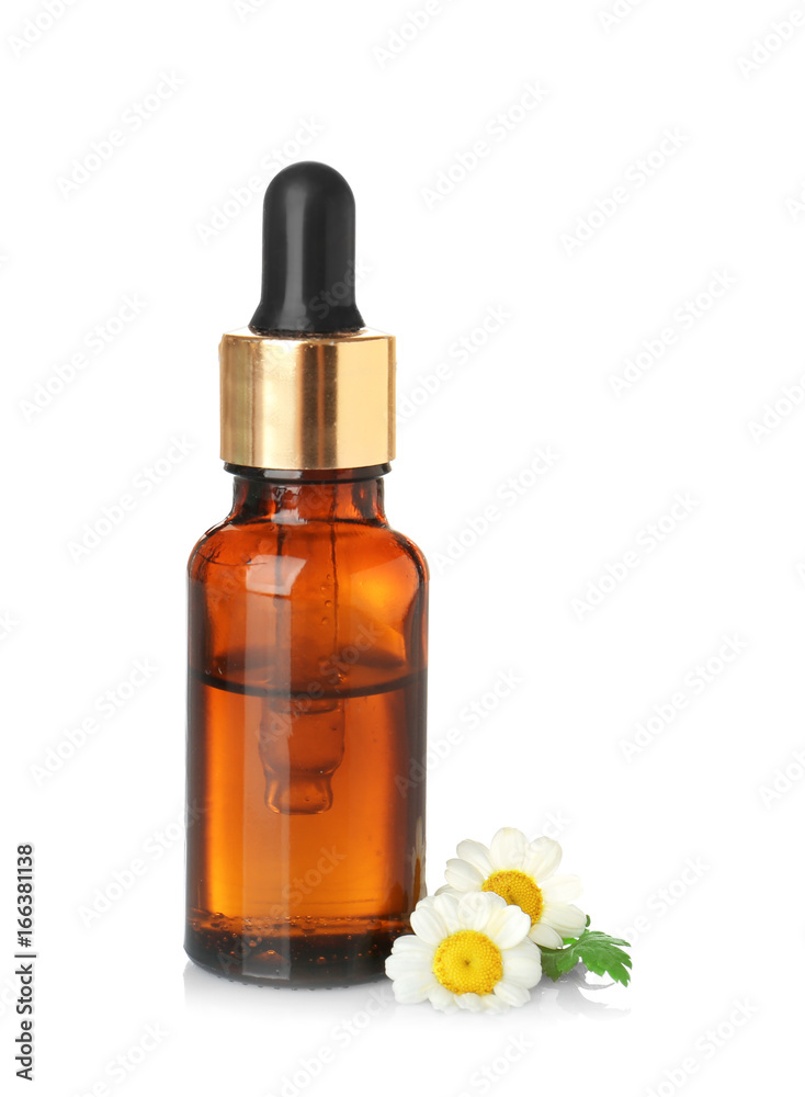Bottle of essential oil and chamomile flowers on white background Bottle of essential oil and chamomile flowers on white background