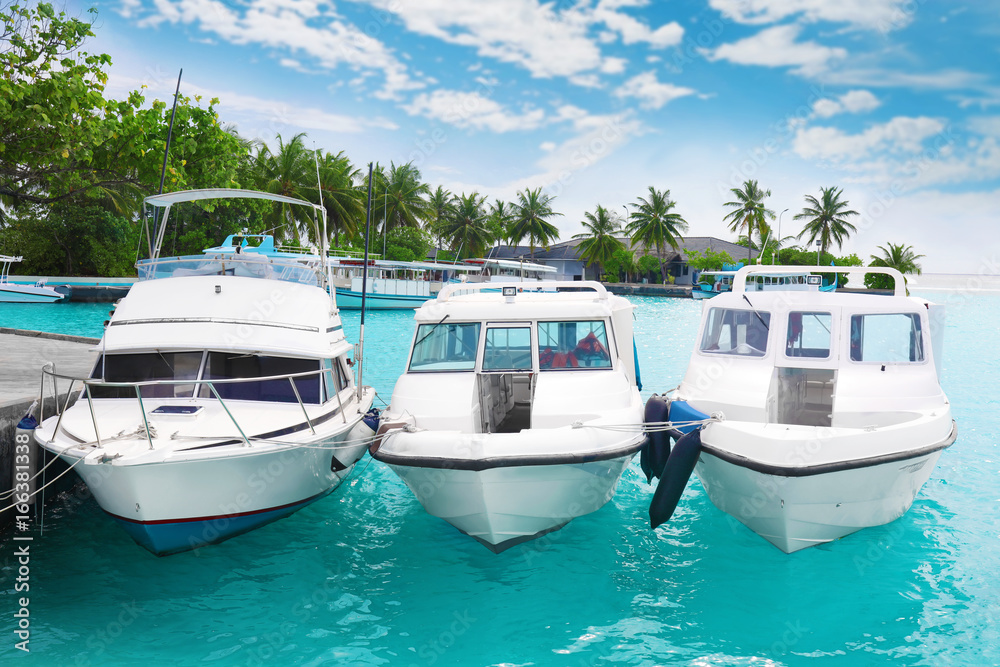 Modern boats berthed at tropical resort Modern boats berthed at tropical resort
