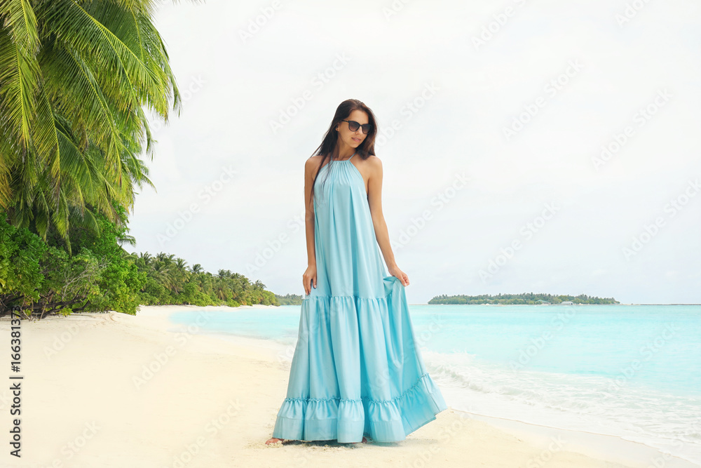 Beautiful young woman on sea beach at tropical resort Beautiful young woman on sea beach at tropical resort
