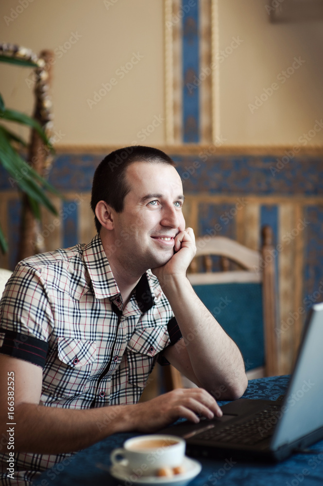 Man working in a cafe on a laptop