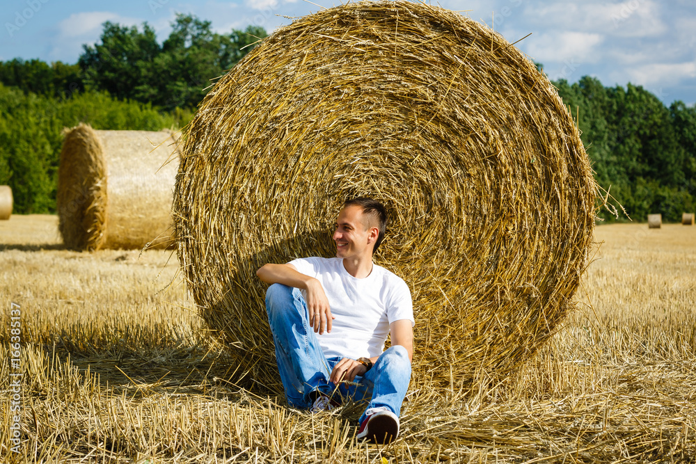 Happy smiling caucasian thirty years old farmer standing proud in front of his wheat fields Happy smiling caucasian thirty years old farmer standing proud in front of his wheat fields