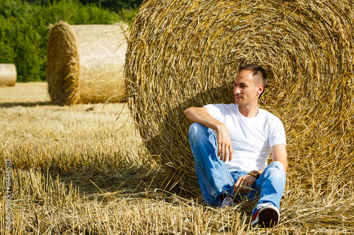 young businessman on yellow wheat field