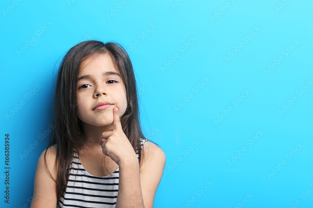 Beautiful little girl in dress on blue background Beautiful little girl in dress on blue background