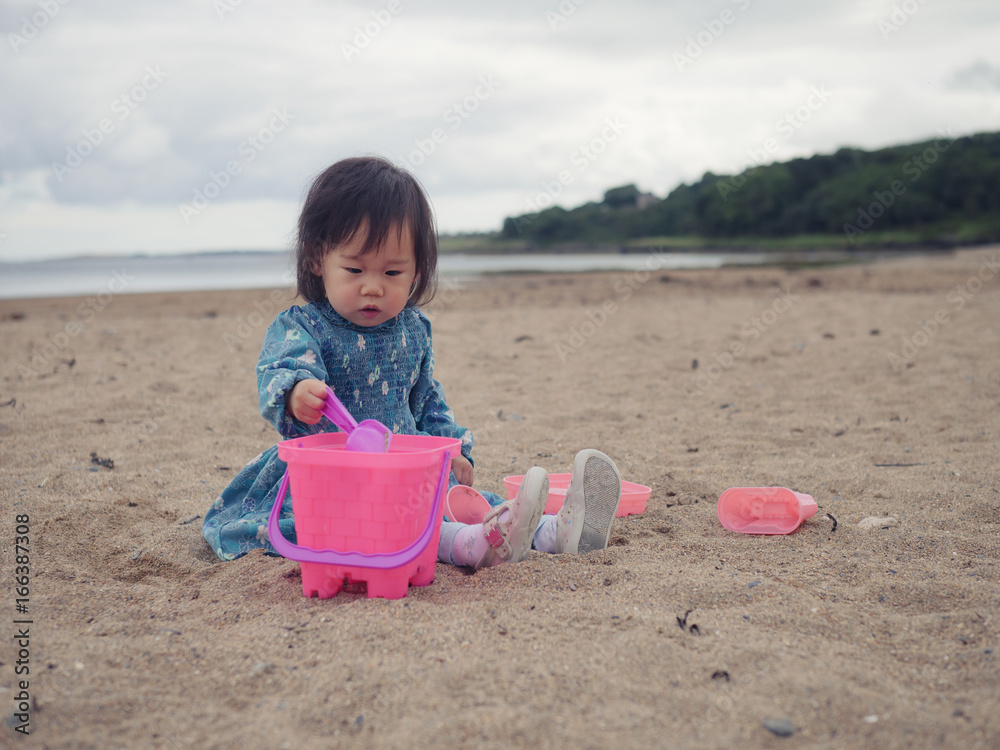 baby girl playing in the sandy beach,Northern Ireland