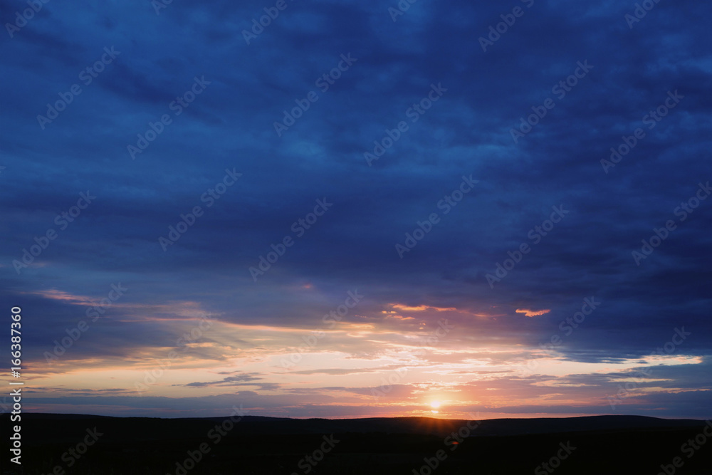 Beautiful sky and field in shadow on sunset Beautiful sky and field in shadow on sunset