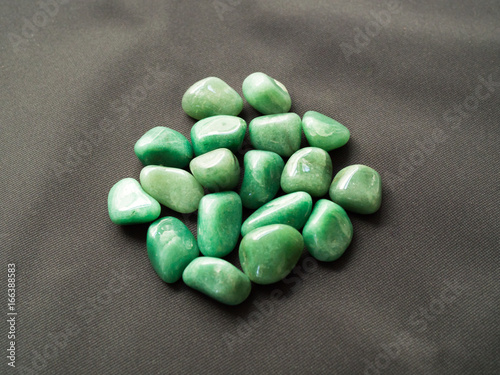 Tumbled aventurine stones for crystal therapy treatments and reiki detail isolated photo