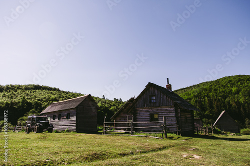 Old wooden village in natural surrounding with blue sky © oleksajewicz