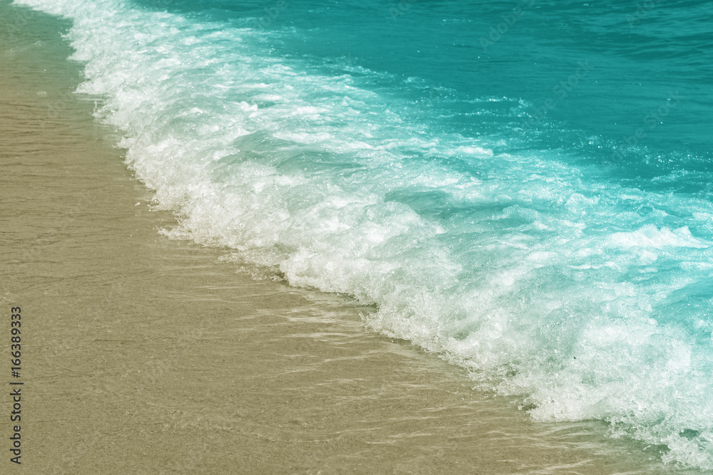 Wave on the shore, blue toning, pastel colors, background.