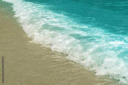 Wave on the shore, blue toning, pastel colors, background.