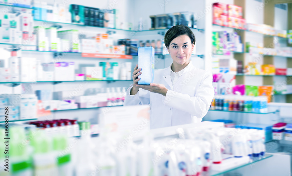 Adult female pharmacist offering products